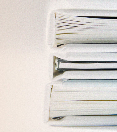 A stack of 3 books that record the legal documents of TriumphFX.